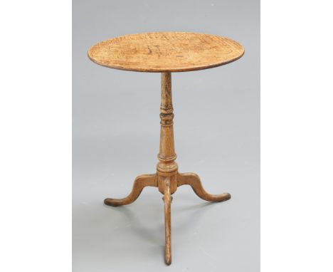 A SMALL GEORGE III OAK TRIPOD TABLE, the oval top raised on a turned stem continuing to hipped downswept legs. 58.5cm high, 4