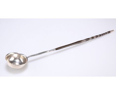 A GEORGE II SILVER METAL PUNCH LADLE, the bowl inset with a George II 1745 LIMA silver shilling, to the twisted horn handle. 