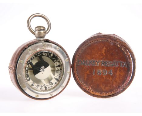A STEEL CASED POCKET COMPASS, BY YEATES &amp; SON, DUBLIN, in a leather case stamped 'DALKEY REGATTA 1894'. 5.7cm diameterThe