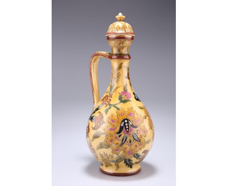 A ZSOLNAY PECS EWER AND COVER, CIRCA 1870-80, decorated in the Persian taste with foliage, the handle in the form of a snake,