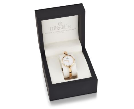 A LADY'S MICHEL HERBELIN BANGLE WATCH. A new and unworn Scandinavian Quartz watch with circular Mother of Pearl dial, gilt do
