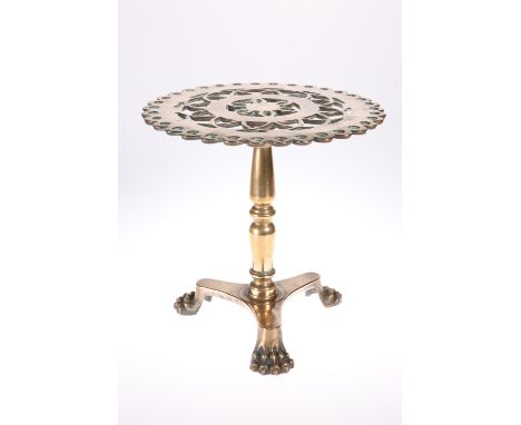 A GOOD VICTORIAN HEAVY BRASS TRIVET, in the form of a tripod table, with pierced top and triform platform base with paw feet.