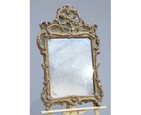 ~ A GROUP OF THREE MIRRORS, the first carved and gilded with acanthus and C-scrolls; the second gilt composition with oval mi