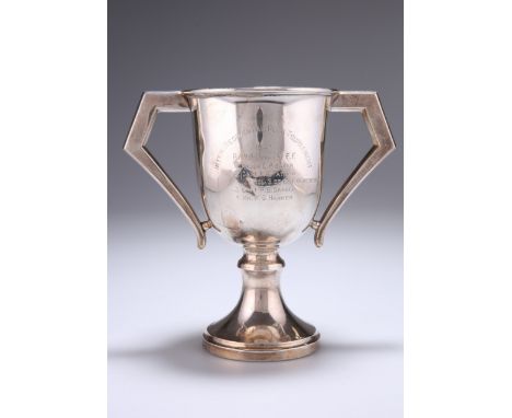 ^ A GEORGE V SILVER TWO-HANDLED TROPHY CUP,&nbsp;by Hamilton &amp; Co (of Calcutta), London 1932, with angular handles, engra