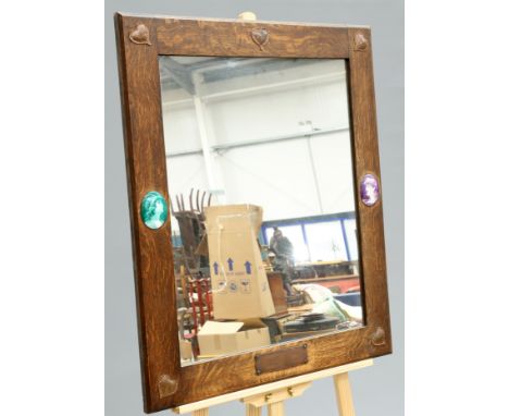 AN UNUSUAL ARTS AND CRAFTS OAK AND COPPER MIRROR, rectangular, to each corner an applied copper heart-shaped plaque, further 