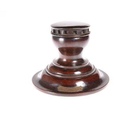 TREEN: A CAPSTAN INKWELL CONSTRUCTED FROM TIMBER TAKEN FROM HMS BRITANNIA, with attached brass plaque. 9.5cm high