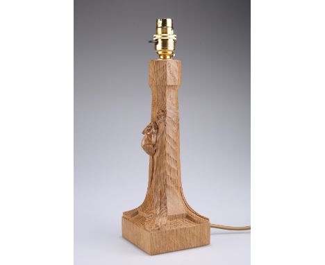 ROBERT THOMPSON OF KILBURNA MOUSEMAN OAK TABLE LAMP with tapering octagonal stem and square base with leaf carved corners, ad