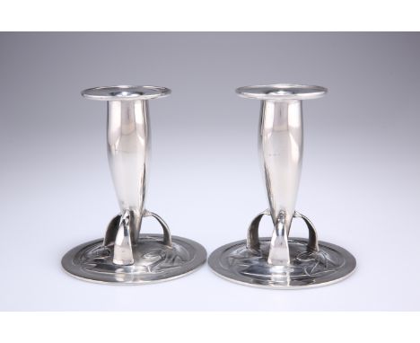 ARCHIBALD KNOX FOR LIBERTY & COA PAIR OF PEWTER CANDLESTICKS, nos. 0221, each torpedo-shaped stem with wide drip-pan, raised 