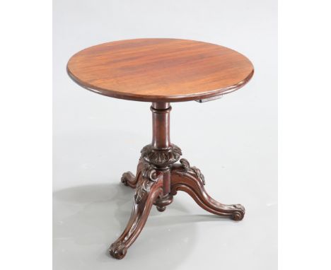 A VICTORIAN MAHOGANY TRIPOD TABLE, the circular top raised on a cylindrical stem with leaf-carved knop, continuing to hipped 