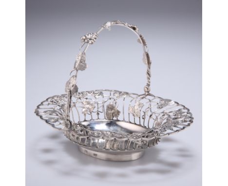 A GEORGIAN SILVER SWEETMEAT BASKET, marks rubbed, the open basket with trailing vine leaves and bunches of grapes, with a swi
