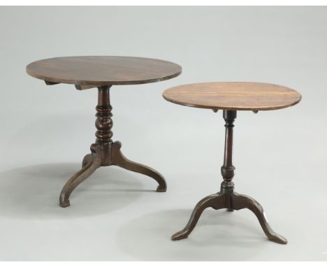 TWO GEORGE III OAK TRIPOD TABLES, each with circular tilt tops and raised on downswept legs (2). Larger 71cm high, 84.5cm wid