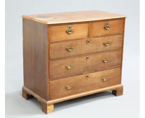 A GEORGE III OAK CHEST OF DRAWERS, the moulded rectangular top over two short over three long drawers, fitted with brass soli