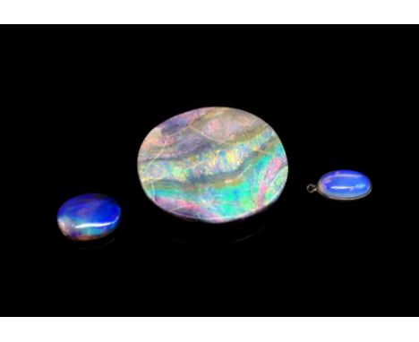 Three loose gemstones includes a large boulder opal A/F, another opal and a moonstone pendant