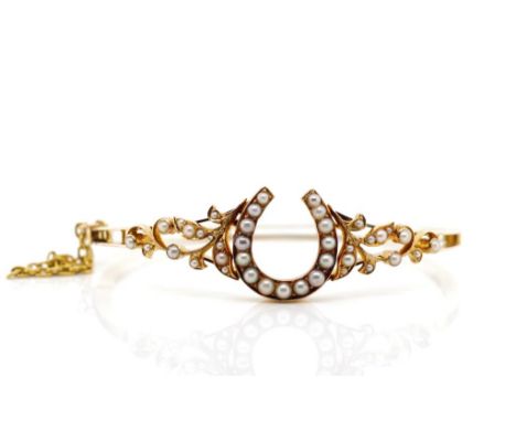 Antique gold and pearl horseshoe bangle unmarked with swivel hinge box clasp and safety chain Approx weight 12.1 grams, insid