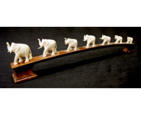 Early carved ivory graduated elephant figure group C1930's,on a carved timber stand, width 22.5cm approx, NB This item may no