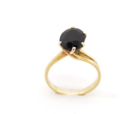 Black gemstone and gold ring marked 14k. Approx weight 3.4 grams, ring size M-N