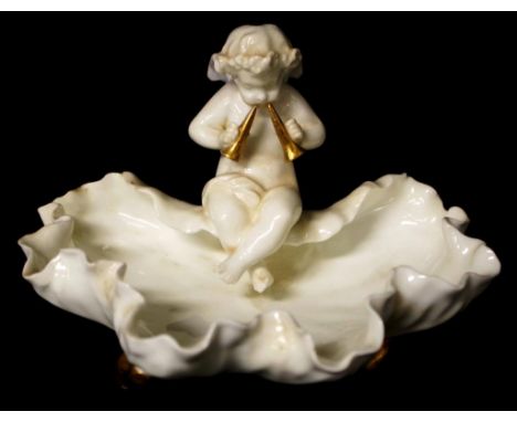 Antique Moore Brothers ceramic figural bowl depicting a Putti seated on a shell form bowl, supported on 3 gilded feet, marked