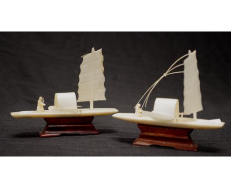 Circa 1930 two carved ivory Chinese junk boats on timber stands, height 8.5cm approx. This item may not be exported.