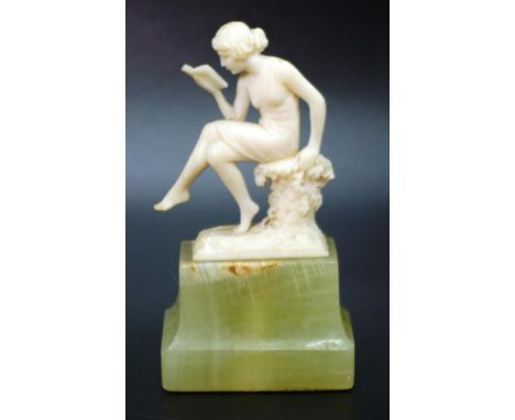 Art Deco ivory seated lady reading a book figure on a green stone base, height 8cm approx, NB This item may not be exported