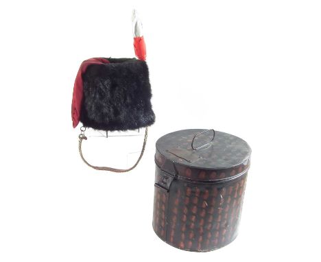 Bearskin hat in case, the tin case bearing the name Capt. R J Streatfield Royal Artillery.