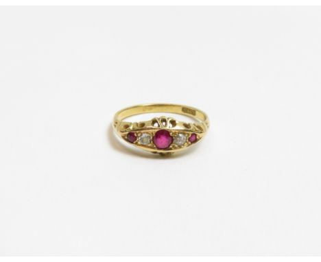 An Edwardian diamond and ruby ring, stamped '18ct', the three small round cut rubies with an old cut diamond between, finger 