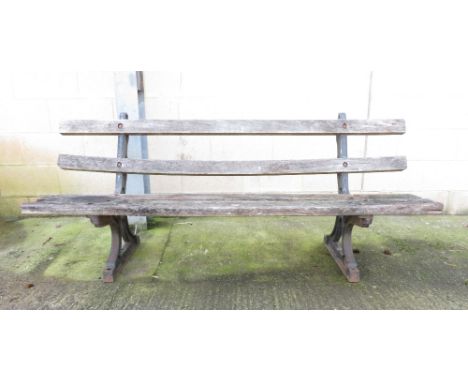 A wooden bench with iron base, 75cm high, 182cm long, 50cm deep