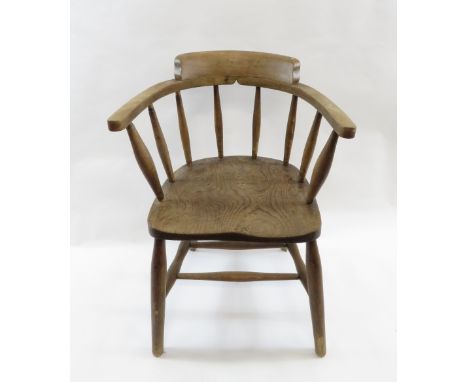 A beech and elm captains chair with stick back and shaped seat