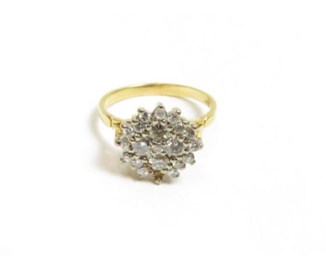 A diamond cluster ring, stamped '18ct', the four central principal brilliant cuts with a small brilliant cut to the middle en