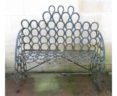 A garden bench composed of horse shoes, 119cm high, 122cm long, 47cm wide