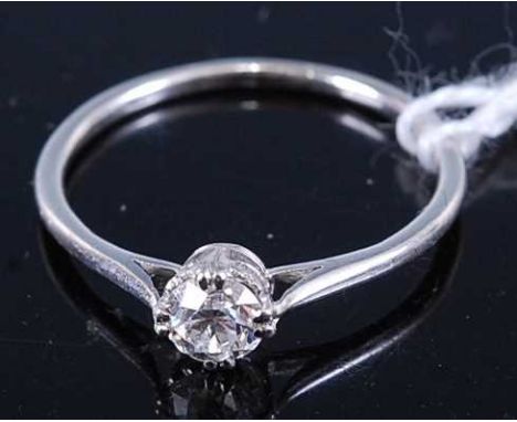 A white metal diamond solitaire ring, the claw set brilliant weighing approx 0.2 carats, 2g, size M