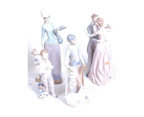 A Lladro Spanish porcelain figure group of a mother and child, h.36cm; together with three other similar Spanish porcelain fi