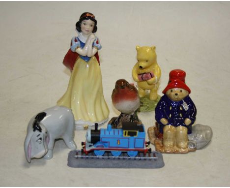 A Royal Doulton Winnie the Pooh collection figure, Winnie Pooh and the present, and Eeyore, a Royal Doulton Snow White and th