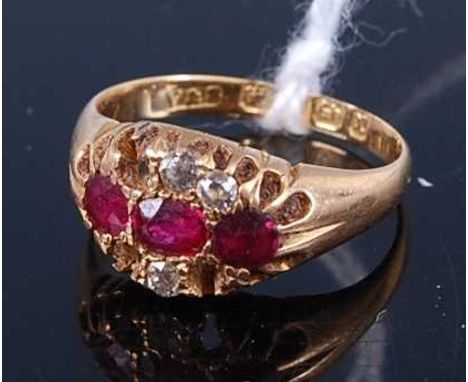 An 18ct gold ruby and diamond dress ring, the stones in a carved setting, Note: three diamonds missing, 3.7g, size K