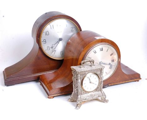 An early 20th century walnut cased Napoleon's hat eight-day mantel clock, with chimes, the silvered dial showing Roman numera