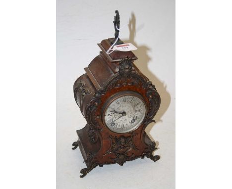 An early 20th century French style walnut and gilt metal mounted eight-day balloon mantel clock, in the Rococo taste, the sil