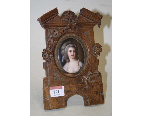 Continental school, late 19th century, head &amp; shoulders portrait of a lady with blue ribbon in her hair, oil on porcelain