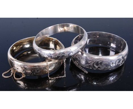 A silver and engraved hinged bangle, maker CPS, Birmingham 1974, together with one other silver gilt example from the period 