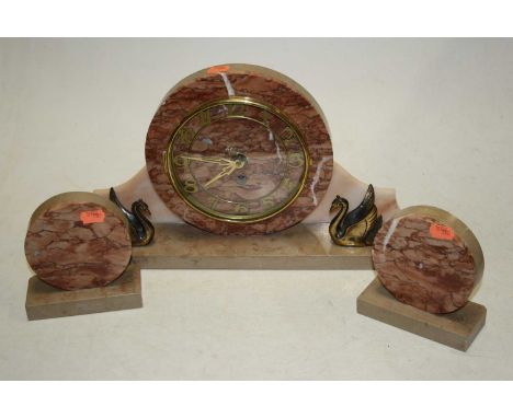 A 1930s Art Deco mantel clock garniture, the rouge marble dial showing Arabic numerals, 23cm high