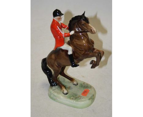 A Beswick figure of a huntsman on rearing horse, model No. 868 in scarlet coat and white breeches, impressed Beswick England 