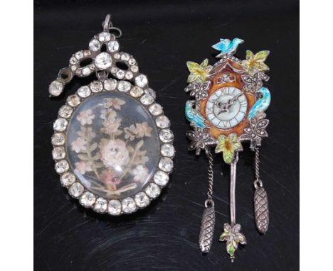 A vintage paste set pendant brooch, inset with silkwork flowers, 5.6cm; together with a white metal and enamel brooch fashion