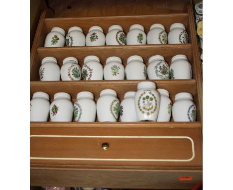 A collection of Franklin Mint Gloria Concepts herb and spice jars, within a spice rack