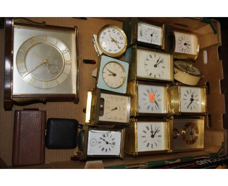 An early 20th century brass carriage clock, of corniche form; together with a large quantity of various carriage, mantel and 