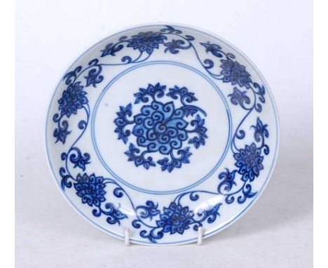 A Chinese export blue and white glazed dish, decorated with trailing lotus, bearing apocryphal Kangxi reign mark to the under