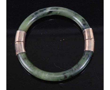 A nephrite gilt metal mounted hinged bangle, 40.7g, dia.8cm