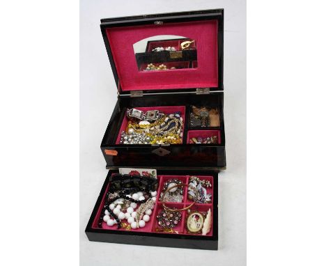 A lacquered jewellery box and contents, to include a faux jet bangle, each link with a topographical scene; rolled gold bangl