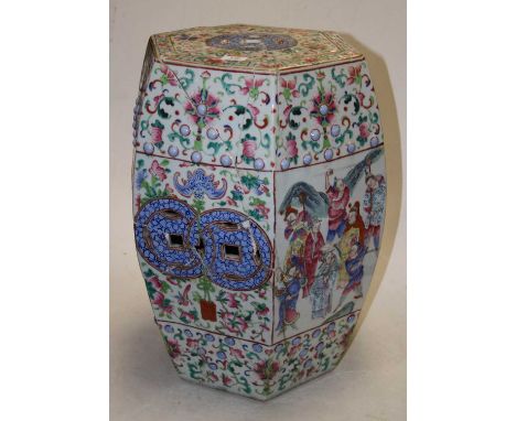 A 19th century Chinese Canton Famille Rose garden seat of hexagonal form, enamel decorated with figures within a mountainous 