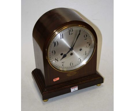 An early 20th century mahogany and boxwood strung mantel clock, the eight day movement with chimes, the silvered dial showing