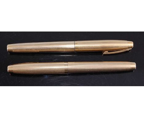A Sheaffer gold-plated fountain pen, having 14ct gold nib; together with a near-matching ballpoint pen in engine turned case 