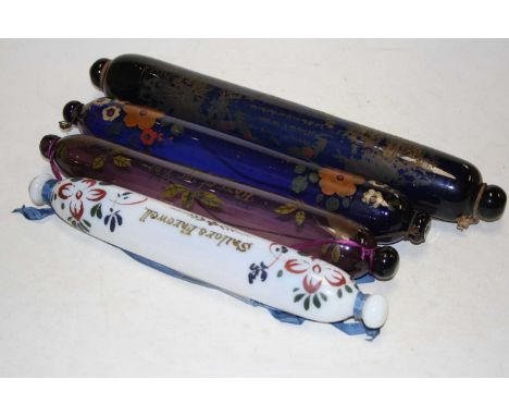 A 19th century Nailsea type glass rolling pin, with gilt decoration, 44cm long, together with three others similar