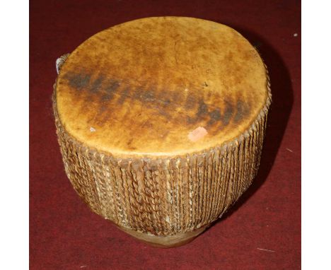 An African cow hide clad drum, 30cm wide, together with a 20th century aboriginal didgeridoo